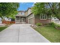 Charming two-story home boasts a manicured lawn, mature trees, and a welcoming front porch at 3389 Willowrun Dr, Castle Rock, CO 80109