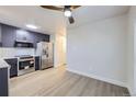 Open-concept kitchen featuring new stainless steel appliances, custom cabinets, and laminate floors at 6491 Barnacle Ct, Boulder, CO 80301