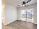 Modern living room with stylish sliding glass door, laminate floors, and contemporary ceiling fan at 6491 Barnacle Ct, Boulder, CO 80301