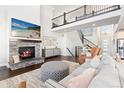 Bright living room with fireplace, hardwood floors, vaulted ceilings, upper gallery and open floor plan at 22463 E Mosey Cir, Parker, CO 80138