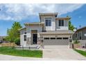 Attractive two-story home boasting stone details, a two-car garage, and green lawn at 10685 Cherrybrook Cir, Highlands Ranch, CO 80126