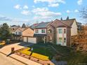 Charming two-story brick home with a three car garage and landscaped front yard at 12752 W Dakota Ave, Lakewood, CO 80228