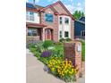 Beautifully landscaped front yard with vibrant flowers and a classic brick mailbox, enhancing curb appeal at 12752 W Dakota Ave, Lakewood, CO 80228