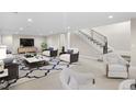 Bright living room featuring a modern staircase, neutral color palette, and stylish decor at 8014 Trinity Peak Ln, Castle Rock, CO 80108