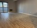 Spacious living room with sliding glass doors and new laminate flooring offers bright natural light at 1011 S Ironton St # 107, Aurora, CO 80012