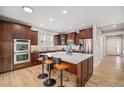 Modern kitchen featuring a large island with seating, stainless steel appliances, and custom cabinetry at 3375 N Willow St, Denver, CO 80238