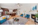 Open-concept living room featuring hardwood floors, a fireplace, and seamless flow to the kitchen at 3375 N Willow St, Denver, CO 80238