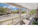 Inviting covered porch with white columns, offering a relaxing outdoor space with neighborhood views at 3375 N Willow St, Denver, CO 80238