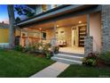 Inviting covered porch with stylish seating and well-maintained landscaping at 2377 S Humboldt St, Denver, CO 80210