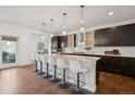 Modern kitchen with a large island, pendant lighting, and stainless steel appliances at 2377 S Humboldt St, Denver, CO 80210