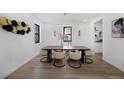 This dining room features modern light fixture, large windows, and hardwood floors at 4176 Zenobia St, Denver, CO 80212