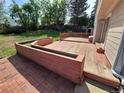Backyard with a wooden deck, a small storage shed, and plenty of grass at 16835 E Harvard Pl, Aurora, CO 80013