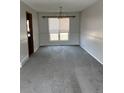 Cozy dining room area featuring gray carpet and a classic chandelier fixture at 16835 E Harvard Pl, Aurora, CO 80013