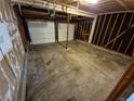Spacious two-car garage with concrete flooring and exposed beams at 16835 E Harvard Pl, Aurora, CO 80013