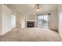Cozy living room with fireplace and sliding doors to balcony at 5255 Memphis St # 224, Denver, CO 80239