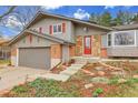 Charming gray two-story home with red shutters, stone accents, a well-kept yard, and a two-car garage at 7148 S Dahlia Ct, Centennial, CO 80122