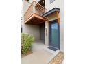Close-up of a modern townhome entrance with stylish door, clear address number, and covered porch at 10154 Belvedere Loop, Lone Tree, CO 80124