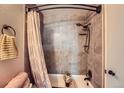 This bathroom boasts updated tile, a rainfall shower head, built in shower shelves, and great decor at 14344 E Hawaii Cir # B, Aurora, CO 80012