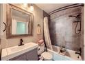 Updated bathroom features a shower and tub combination, a modern vanity, and updated tiling at 14344 E Hawaii Cir # B, Aurora, CO 80012