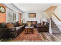 Cozy living room with hardwood floors, plush furniture, and natural light at 625 S Xenon Ct, Lakewood, CO 80228