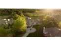 Stunning aerial view of home with mature trees and circle driveway at 4935 E Preserve Ln, Greenwood Village, CO 80121