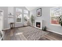 Light-filled living room with vaulted ceilings, fireplace, wood floors, and neutral decor at 12742 Vrain St, Broomfield, CO 80020