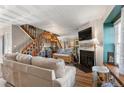 Inviting living room boasts a cozy fireplace, staircase, and stylish decor at 17467 E Rice Cir # C, Aurora, CO 80015