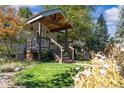 Attractive home featuring a covered front porch, lush greenery, and a welcoming entrance at 4645 Quitman St, Denver, CO 80212
