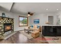 Inviting living room features a cozy fireplace, ceiling fan and stylish furnishings for a relaxing ambiance at 5250 S Huron Way # 3-205, Littleton, CO 80120