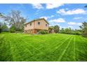 Spacious lawn and a charming two-story home with ample backyard space at 1335 S Kio St, Watkins, CO 80137