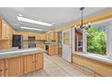 Bright kitchen with wooden cabinets, granite countertops, and a large window at 1335 S Kio St, Watkins, CO 80137