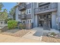 Inviting condo exterior with updated facade, lush greenery, and easy access walkway at 7893 Allison Way # 101, Arvada, CO 80005