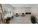 Bright living room with stone fireplace, ample windows, and modern decor at 2230 Jamaica, Aurora, CO 80010