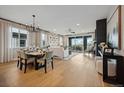 Open-concept living and dining area with ample natural light and stylish furnishings at 8360 Snake River St, Littleton, CO 80125
