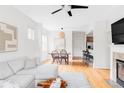 Open-concept living room with dining area and kitchen access, featuring hardwood floors at 9124 E 29Th Pl, Denver, CO 80238