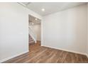 Open living room featuring wood floors and a view into the entryway and staircase at 3352 N Highlands Creek Pkwy, Aurora, CO 80019