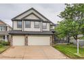 Traditional two-story home with three-car garage, stone accents, and a well-manicured lawn at 22367 Quail Run Dr, Parker, CO 80138