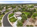 Expansive aerial view showcases this stunning home with lush greenery, manicured landscaping, and neighborhood at 8518 High Ridge, Castle Pines, CO 80108