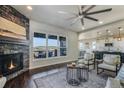 Bright living room with a fireplace that is open to the kitchen area, creating a sociable space at 16088 Denver Pacific Dr, Monument, CO 80132