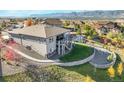 Beautiful backyard features a spacious deck, lush lawn, and scenic views of the mountains at 16088 Denver Pacific Dr, Monument, CO 80132