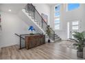 Inviting foyer with a modern staircase, stylish decor, wood floors and abundant natural light at 3564 Doubletrack Ln, Castle Rock, CO 80108