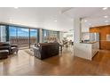 Bright living room featuring hardwood floors, floor-to-ceiling windows, and an open floor plan at 1020 15Th St # 42A, Denver, CO 80202