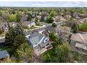 Beautiful home nestled amongst mature trees in a quiet neighborhood with lush green landscaping at 1792 W Kettle Ave, Littleton, CO 80120