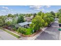 This aerial view shows a home with a fenced yard, landscaping, and mature trees at 5007 S Richfield Cir, Aurora, CO 80015