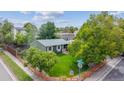 Aerial shot of a well-maintained home with a fenced yard and mature trees at 5007 S Richfield Cir, Aurora, CO 80015