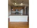 Modern kitchen featuring stainless steel appliances and granite countertops and breakfast bar seating at 1441 Central St # 211, Denver, CO 80211