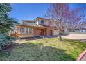 Charming two-story home with a brick and siding facade and well-maintained lawn at 8167 S Dover St, Littleton, CO 80128