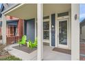Welcoming front porch featuring modern design, neutral colors and two bright green Adirondack chairs at 35 Elati St, Denver, CO 80223