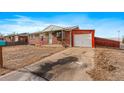 Front view of brick ranch home with driveway and garage at 5493 Quari St, Denver, CO 80239