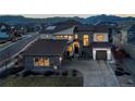 Stunning dusk aerial view of the neighborhood highlighting the exterior facade and mountain views at 9455 Flattop St, Arvada, CO 80007